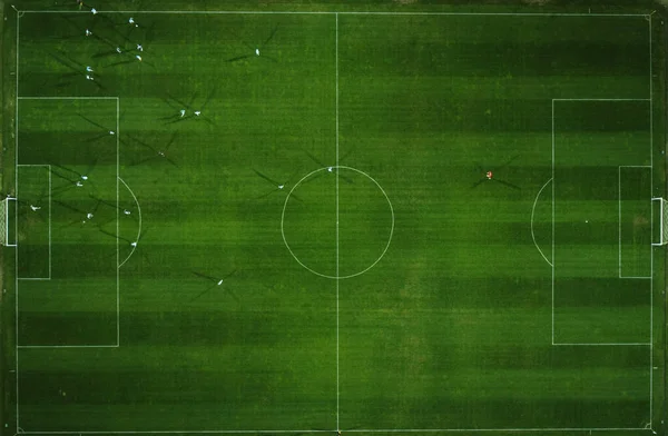 Aerial view of a football match, soccer. Football field and Footballers from drone top down view