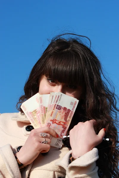 Happy girl with a fan with five thousandth bills — Stock Photo, Image