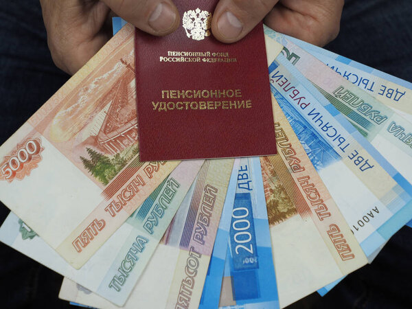 Pensioner's certificate and Russian money in men's hands