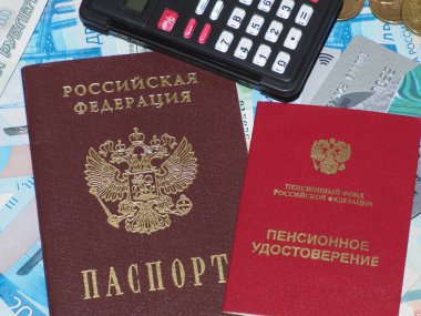 Emekli maaşı alıyorum. Emekli belgesi, Rus pasaportu, hesap makinesi ve plastik kartlar Rus parasının üzerinde.