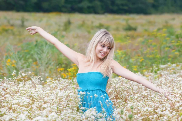 Flickan i ett blommande fält — Stockfoto