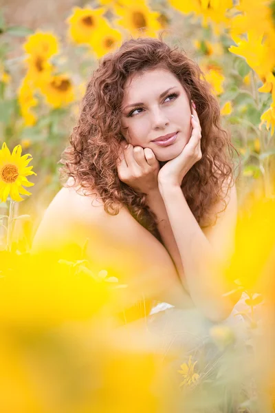 Beautiful young topless girl in summer sunflowers — Stock Photo, Image