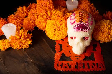 Sugar skull with Candles, Cempasuchil flowers or Marigold and Papel Picado. Decoration traditionally used in altars for the celebration of the day of the dead in Mexico clipart