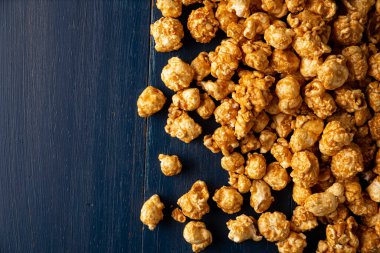 Heap of Caramel Corn Background on blue rustic table