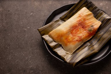 Prehispanic dish typical of Mexico and some Latin American countries. Corn dough wrapped in banana leaves. The tamales are steamed. 