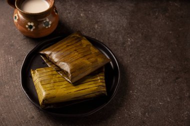 Prehispanic dish typical of Mexico and some Latin American countries. Corn dough wrapped in banana leaves. The tamales are steamed. 