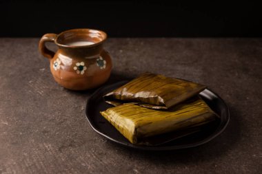 Prehispanic dish typical of Mexico and some Latin American countries. Corn dough wrapped in banana leaves. The tamales are steamed. 