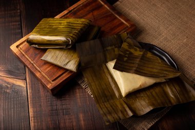 Prehispanic dish typical of Mexico and some Latin American countries. Corn dough wrapped in banana leaves. The tamales are steamed. 