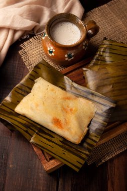 Prehispanic dish typical of Mexico and some Latin American countries. Corn dough wrapped in banana leaves. The tamales are steamed. 