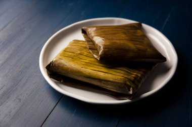 Prehispanic dish typical of Mexico and some Latin American countries. Corn dough wrapped in banana leaves. The tamales are steamed. 