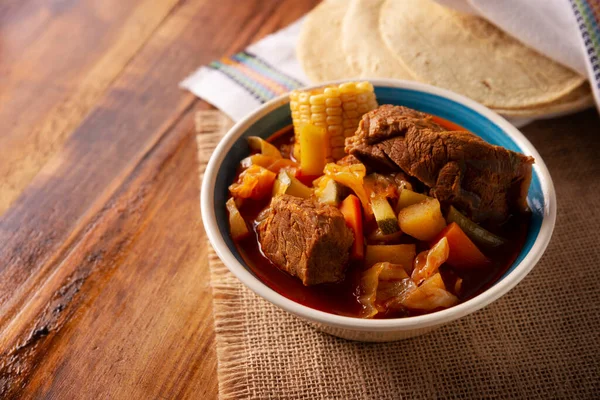 Mole de Olla. It is a balanced one pot meal, typical dish of the central region of Mexico, it is a soup-type stew based on beef and vegetables. It is consumed hot and accompanied with corn tortillas.