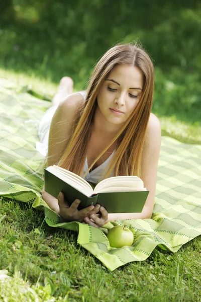 Kitap okuyan genç bir kadın — Stok fotoğraf