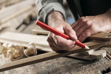 Carpenter Marking a Wooden Plank clipart