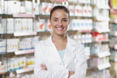 Portrait of Smiling Woman Pharmacist in Pharmacy clipart