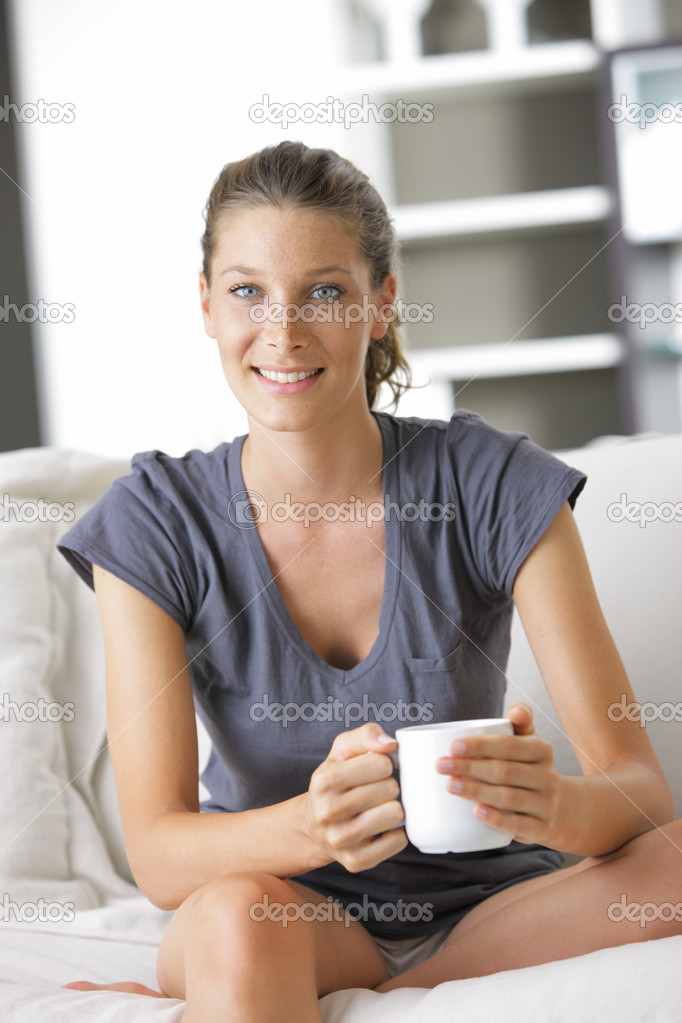 Cute young lady with a cup of coffee