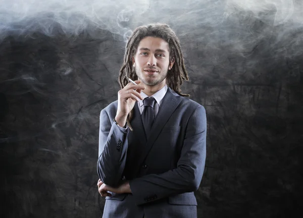 Businessman smoking a joint — Stock Photo, Image