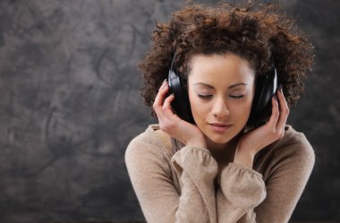 young woman enjoying music clipart