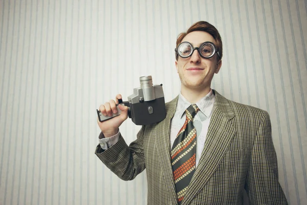 Nerdy businessman with old fashioned cine camera — Stock Photo, Image