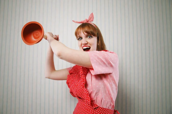 Angry housewife with plunger — Stock Photo, Image