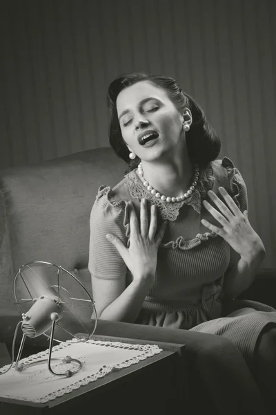 Woman cooling herself with fan — Stock Photo, Image