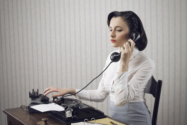 Woman talking on phone at desk