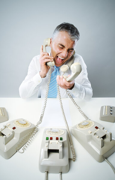 Businessman yelling into phone