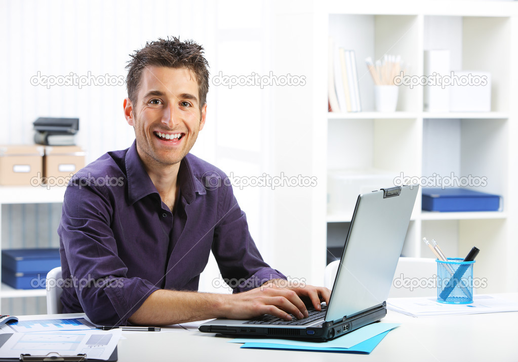 Happy man working on laptop