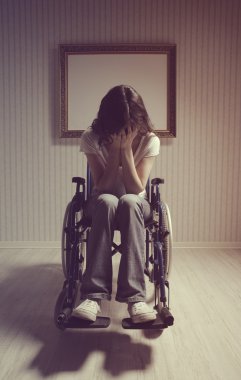 Crying woman sitting in wheelchair