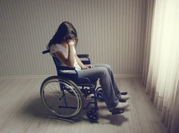 Piangere donna seduta in sedia a rotelle — Foto Stock