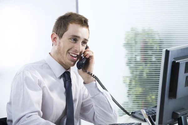 A cheerful businessman talking on phone — Stock Photo, Image