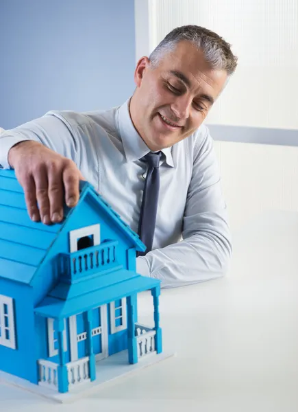 Real estate agent with model house — Stock Photo, Image