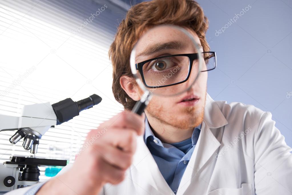 Young researcher with magnifier