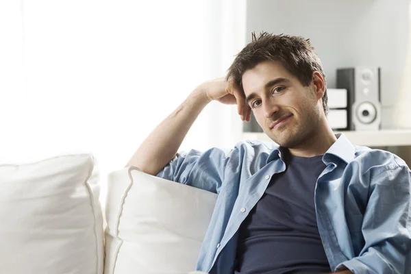 Young man relaxing on sofa — Stock Photo, Image