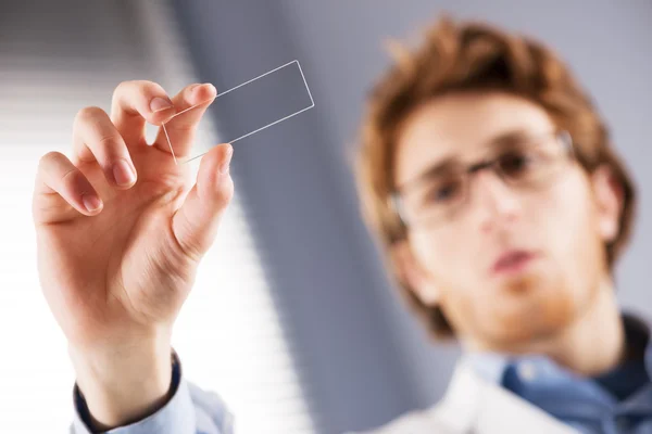 Researcher holding microscope slide — Stock Photo, Image