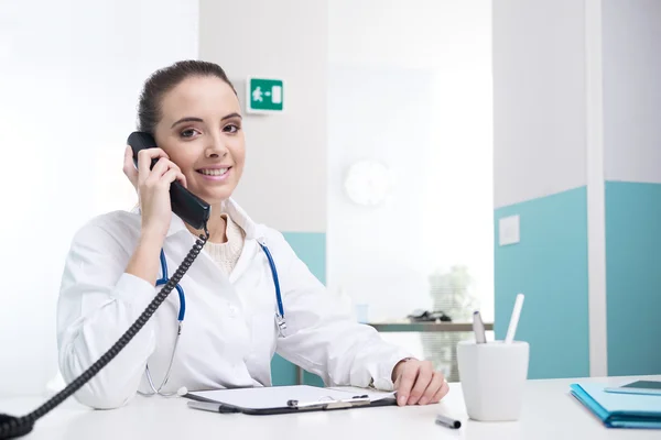Doctor talking on phone Royalty Free Stock Images