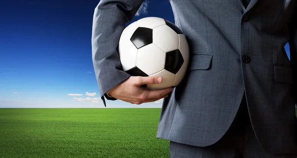 Businessman holding a soccer ball — Stock Photo, Image