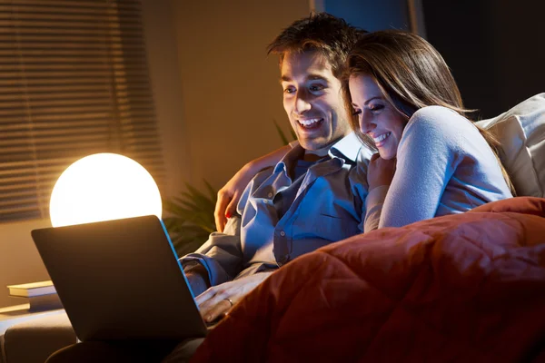 Jeune couple à la maison avec ordinateur portable — Photo