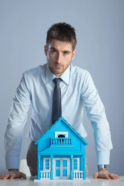 Real estate agent with model house — Stock Photo, Image