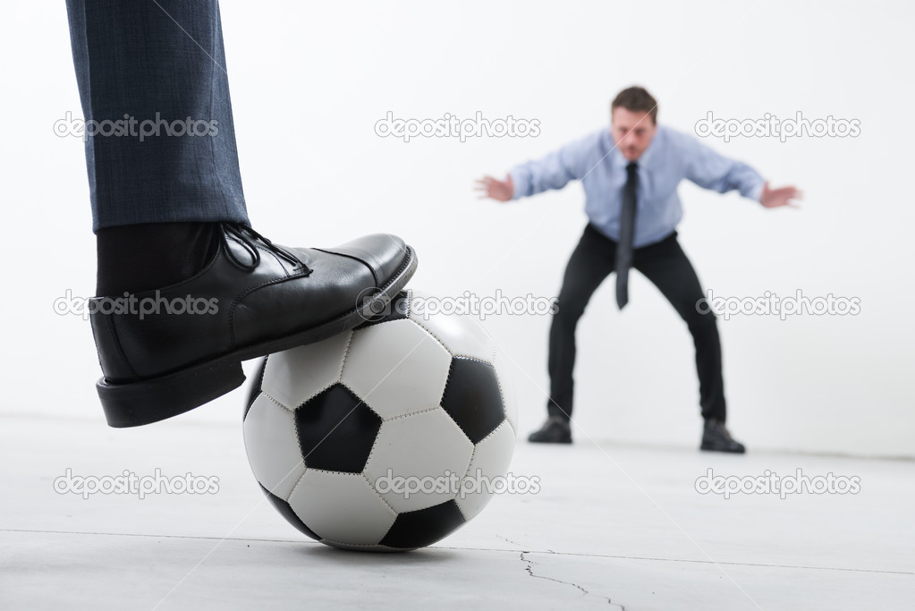 Businessmen playing soccer