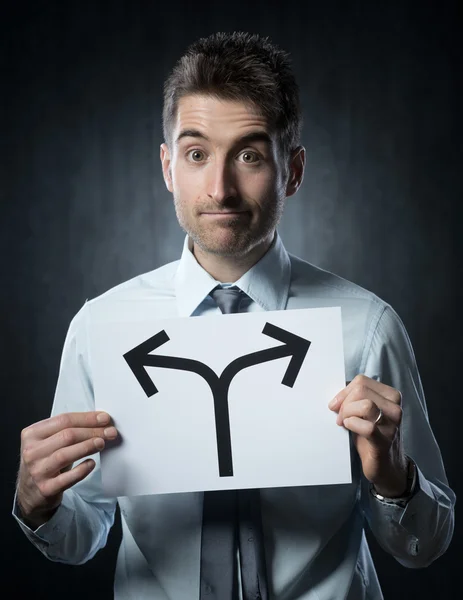 Man holding a sign with directions — Stock Photo, Image