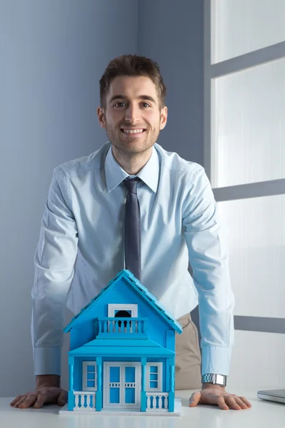 Real estate agent with model house — Stock Photo, Image