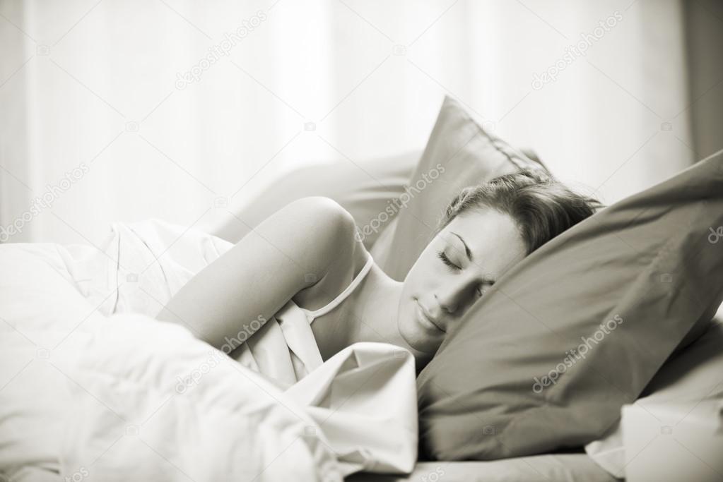 Woman sleeping comfortably on bed