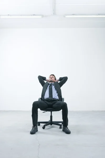 Businessman sitting on office chair — Stock Photo, Image