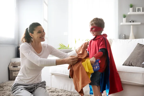 Little superhero helping his mother — Stock Photo, Image