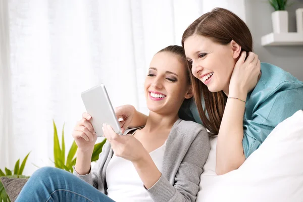 Smiling girls with tablet — Stock Photo, Image