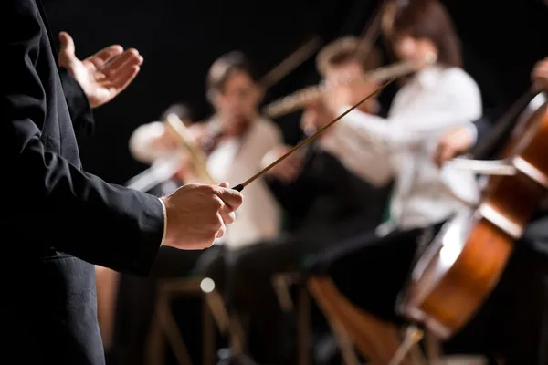 Orchestra conductor on stage — Stock Photo, Image