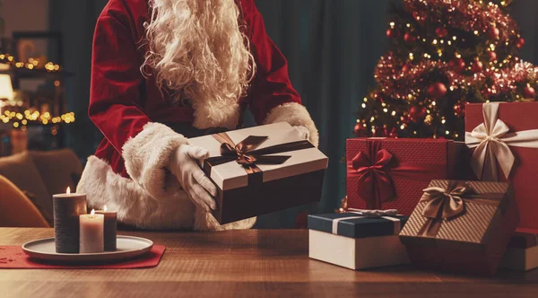 Jultomten Lägger Julklappar Ett Bord Semester Och Fest Koncept — Stockfoto