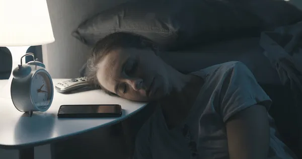 Εξαντλημένη Γυναίκα Ξαπλωμένη Στο Κομοδίνο Και Κοιμάται Αργά Βράδυ — Φωτογραφία Αρχείου