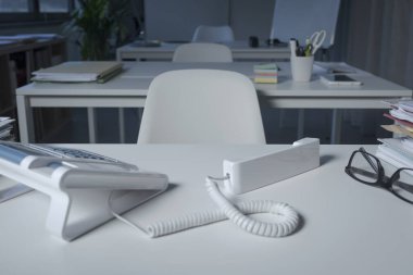 Ofis masaüstü telefonu, alıcısı kapalı.