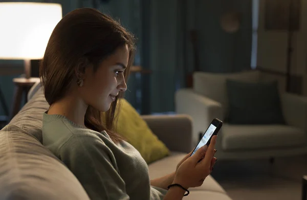 Smiling Teenager Relaxing Sofa Connecting Online Her Smartphone She Social — стоковое фото